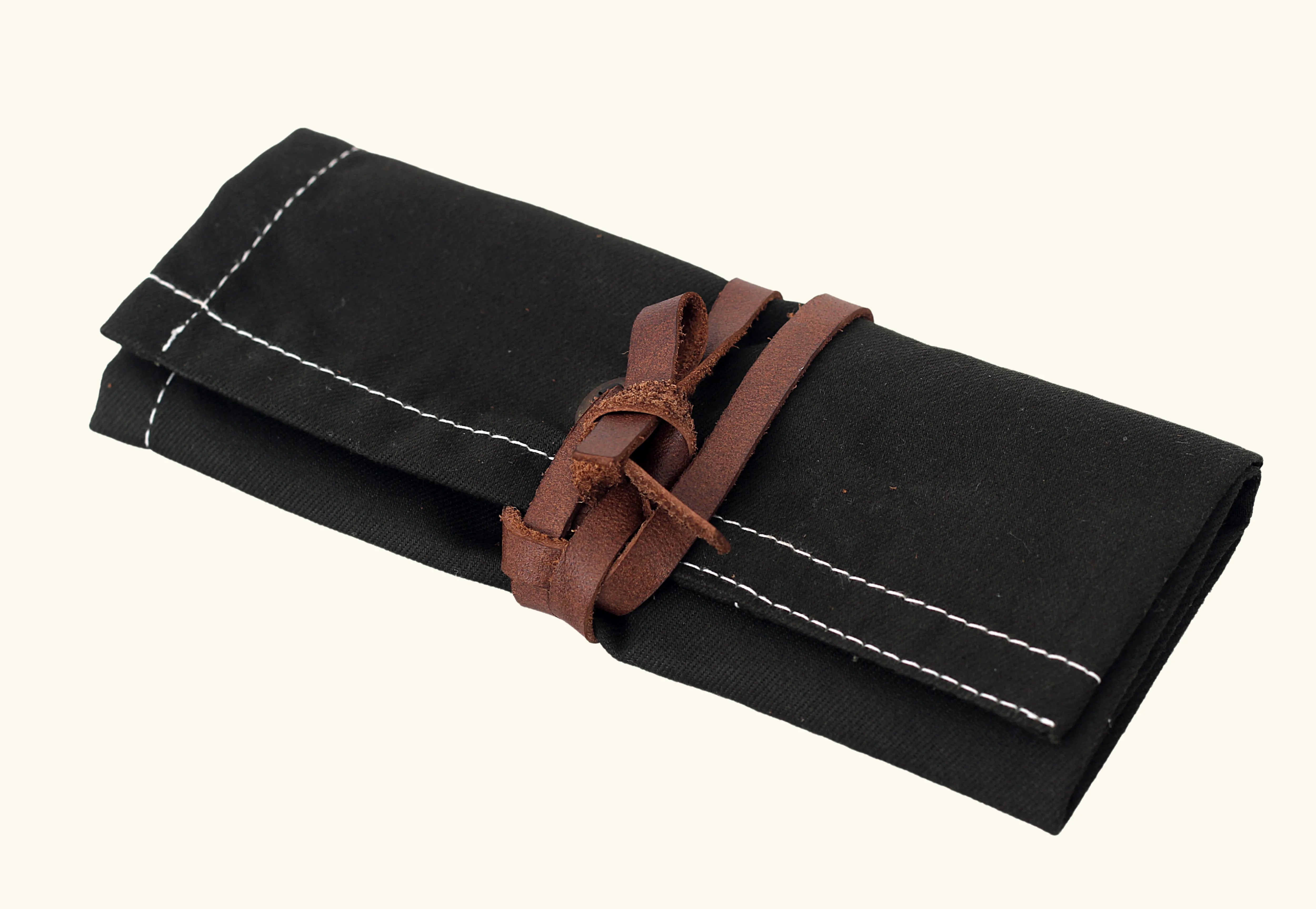 Black canvas tool roll, foldable storage pouch, roll-up tool bag, canvas utility roll, leather strap closure pouch, compact tool organizer, handmade tool holder, artisan tool wrap, canvas pouch with leather tie, heavy-duty canvas tool roll, cotton canvas storage case, durable fabric tool organizer, multi-pocket tool roll, portable tool wrap, hand tool storage pouch, tool kit roll for professionals, brush or tweezer roll case, minimalist tool pouch, rustic style tool roll, black pouch with white stitching,