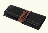 Black canvas tool roll, foldable storage pouch, roll-up tool bag, canvas utility roll, leather strap closure pouch, compact tool organizer, handmade tool holder, artisan tool wrap, canvas pouch with leather tie, heavy-duty canvas tool roll, cotton canvas storage case, durable fabric tool organizer, multi-pocket tool roll, portable tool wrap, hand tool storage pouch, tool kit roll for professionals, brush or tweezer roll case, minimalist tool pouch, rustic style tool roll, black pouch with white stitching,