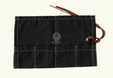 Black canvas tool roll, foldable storage pouch, roll-up tool bag, canvas utility roll, leather strap closure pouch, compact tool organizer, handmade tool holder, artisan tool wrap, canvas pouch with leather tie, heavy-duty canvas tool roll, cotton canvas storage case, durable fabric tool organizer, multi-pocket tool roll, portable tool wrap, hand tool storage pouch, tool kit roll for professionals, brush or tweezer roll case, minimalist tool pouch, rustic style tool roll, black pouch with white stitching,