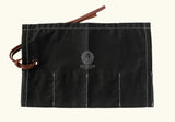 Black canvas tool roll, foldable storage pouch, roll-up tool bag, canvas utility roll, leather strap closure pouch, compact tool organizer, handmade tool holder, artisan tool wrap, canvas pouch with leather tie, heavy-duty canvas tool roll, cotton canvas storage case, durable fabric tool organizer, multi-pocket tool roll, portable tool wrap, hand tool storage pouch, tool kit roll for professionals, brush or tweezer roll case, minimalist tool pouch, rustic style tool roll, black pouch with white stitching,